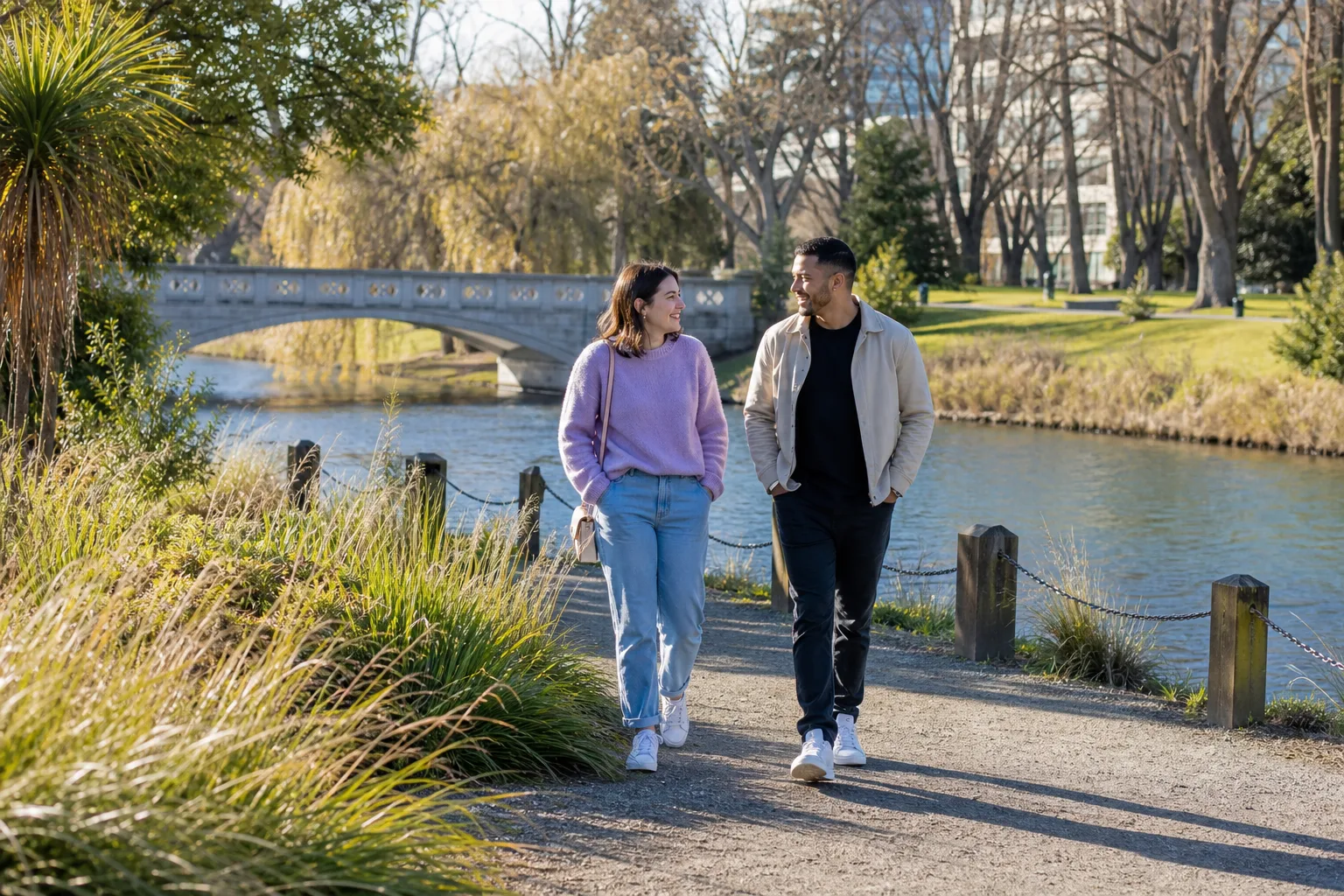 A couple walking beside the Avon River in central Christchurch